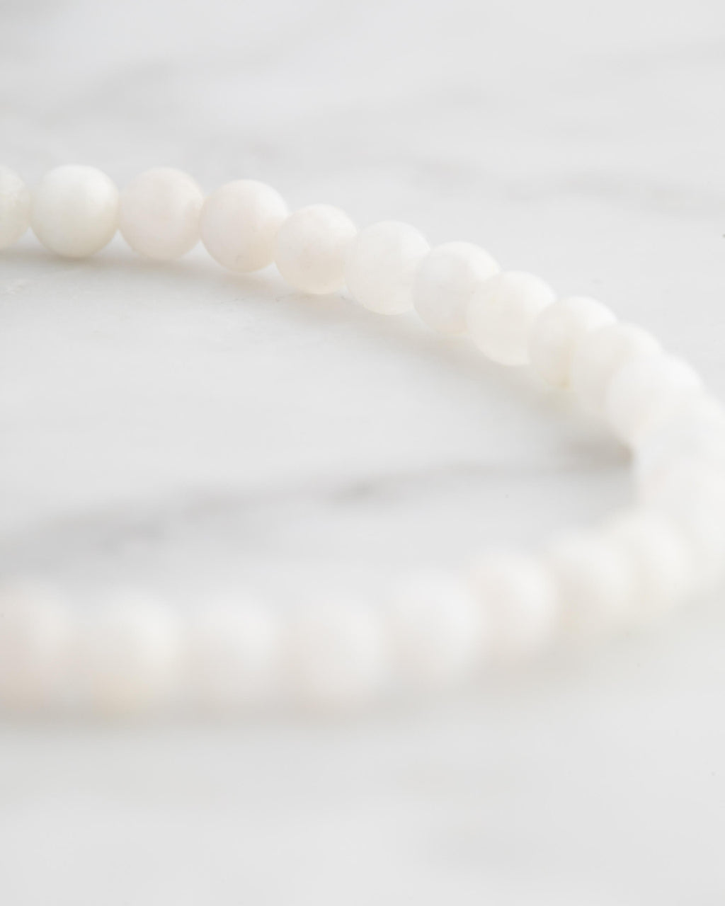 Pulsera de Piedra Luna en ángulo cercano sobre superficie de mármol claro