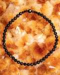 Pulsera de Turmalina Negra facetada, pieza completa en círculo sobre citrino