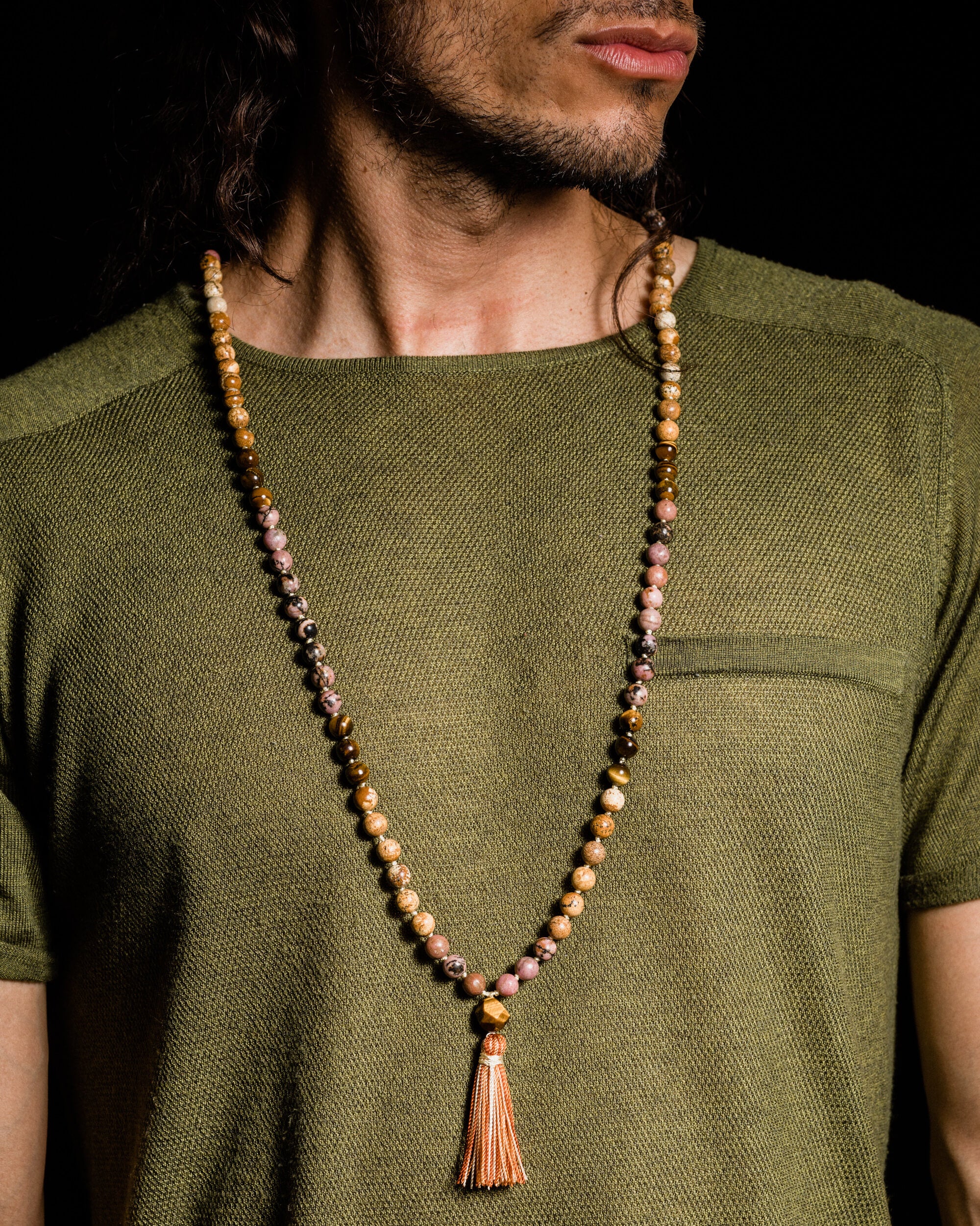 Japa Mala Gaia puesto sobre el cuello, con borla naranja visible