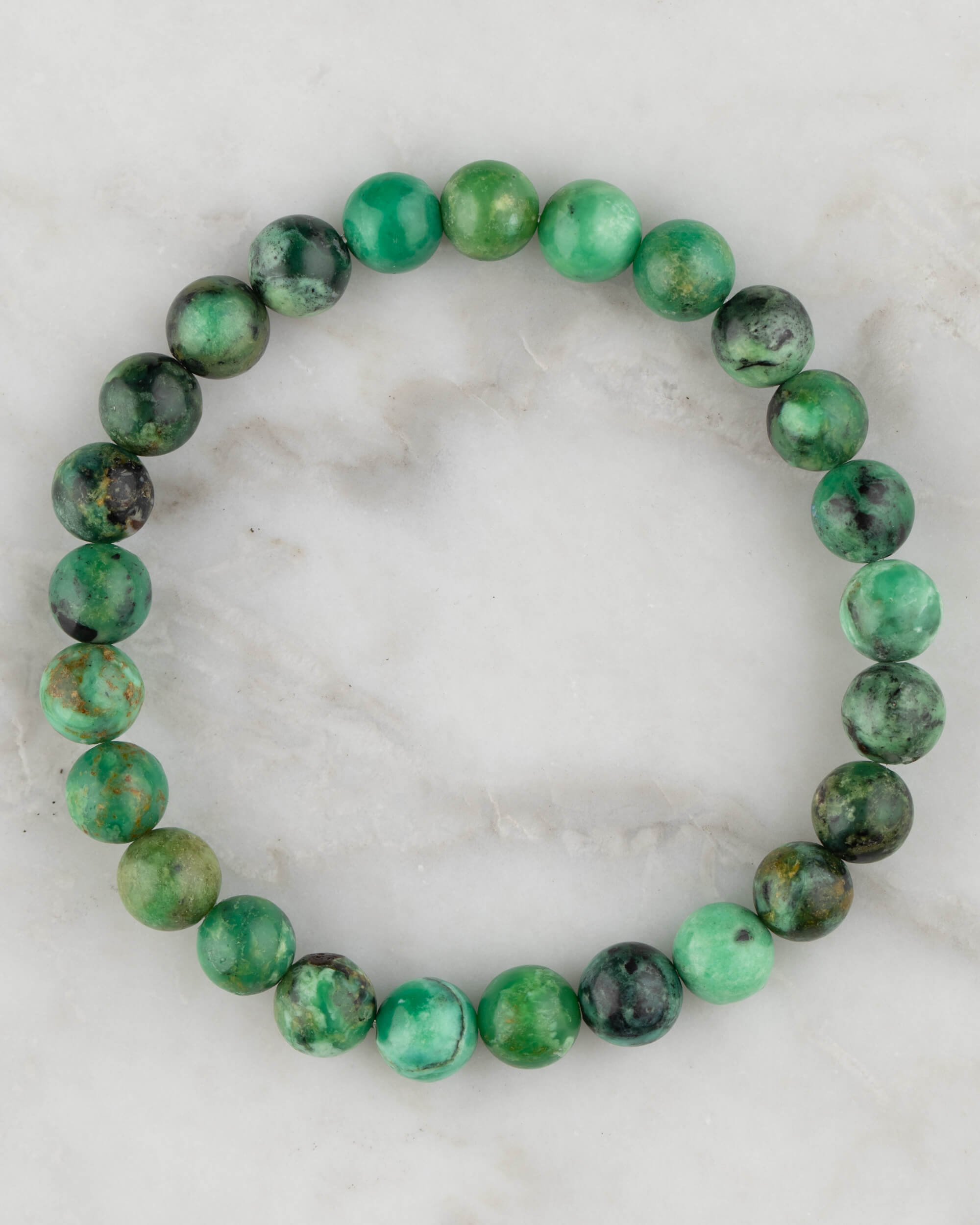 Pulsera de Variscita de 8 mm, pieza completa en círculo sobre mármol claro