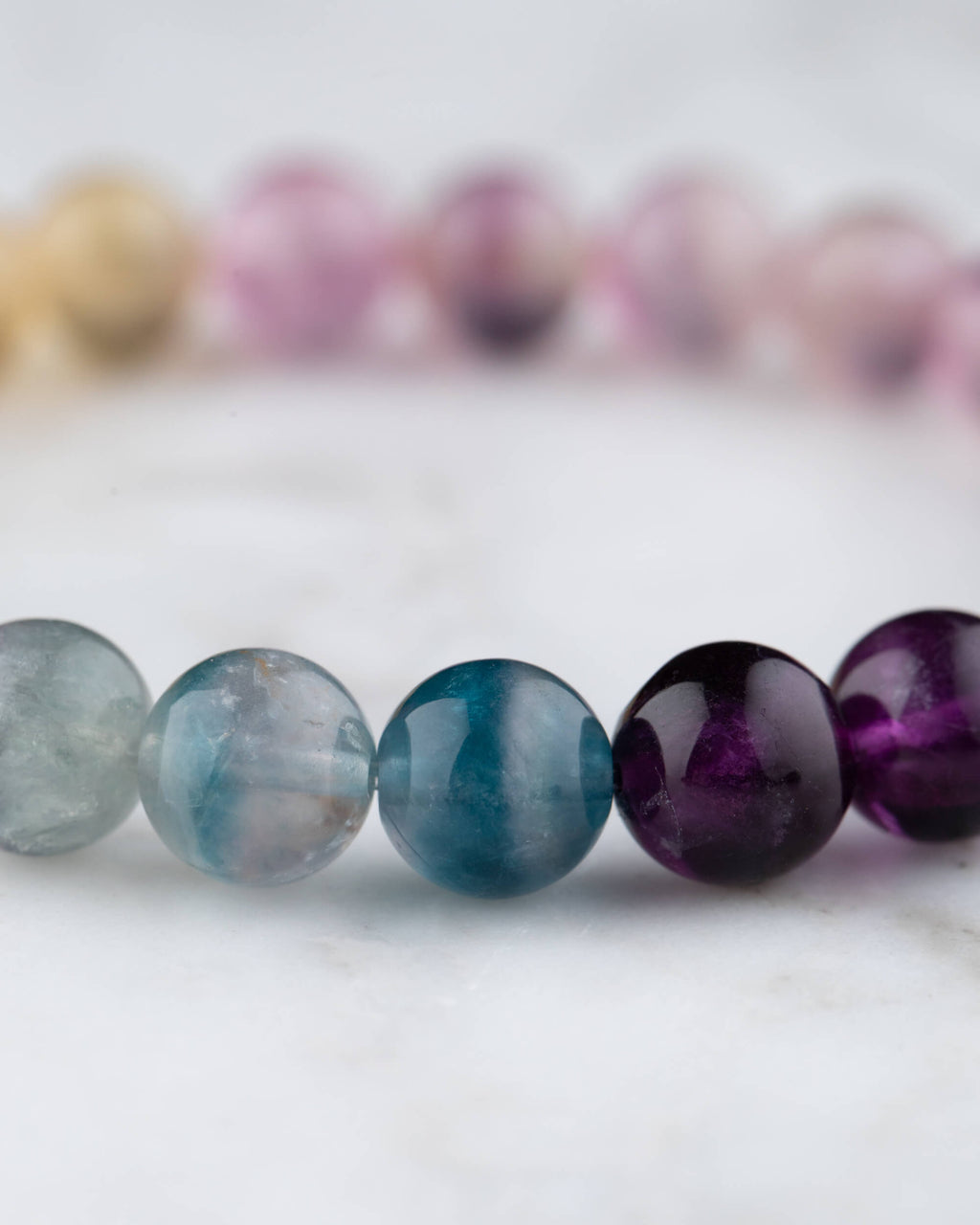 Cuentas de Fluorita Arcoiris en azul, morado y ambar, detalle de la pulsera