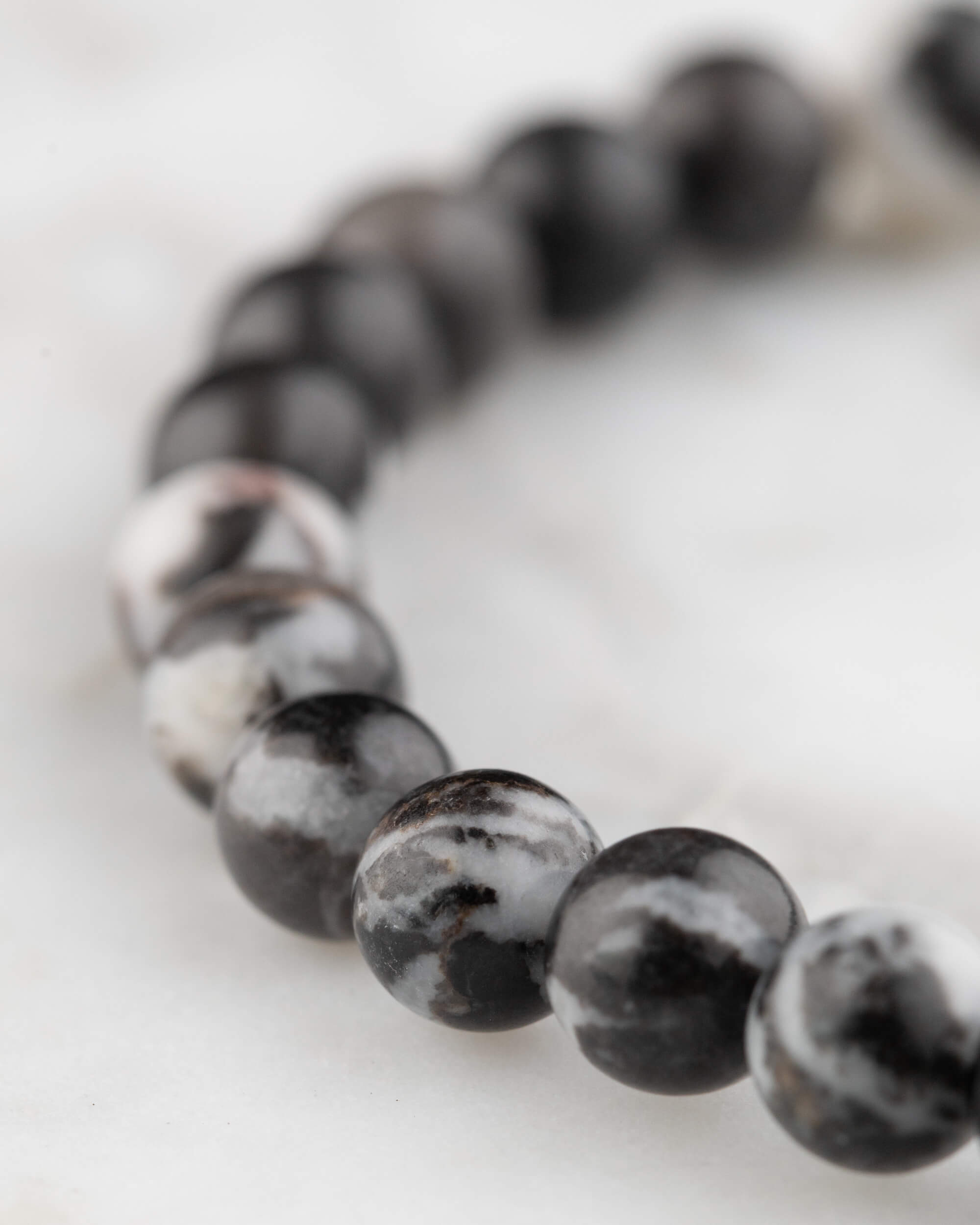 Pulsera de Jaspe Cebra vista en angulo, contraste de cuentas negras y blancas