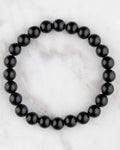 Pulsera de Obsidiana Negra de 8 mm, pieza completa en círculo sobre mármol claro