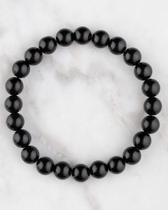 Pulsera de Obsidiana Negra de 8 mm, pieza completa en círculo sobre mármol claro