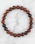 Pulsera de Obsidiana Caoba de 8 mm, pieza completa en círculo sobre superficie de mármol