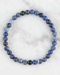 Pulsera de Sodalita de 6 mm, pieza completa en círculo sobre superficie de mármol