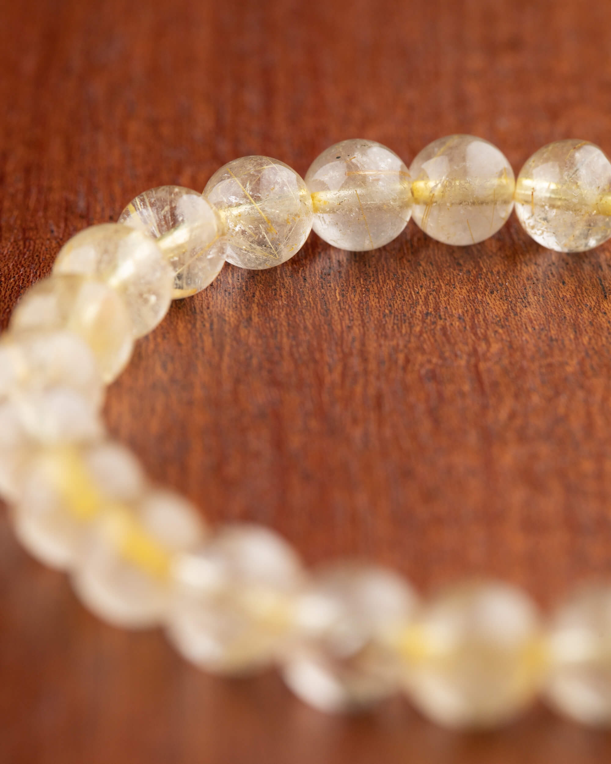 Pulsera de Cuarzo Rutilado, vista en perspectiva mostrando las hebras doradas internas