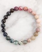 Pulsera de Turmalina Multicolor de 8 mm, pieza completa en círculo sobre superficie de mármol claro