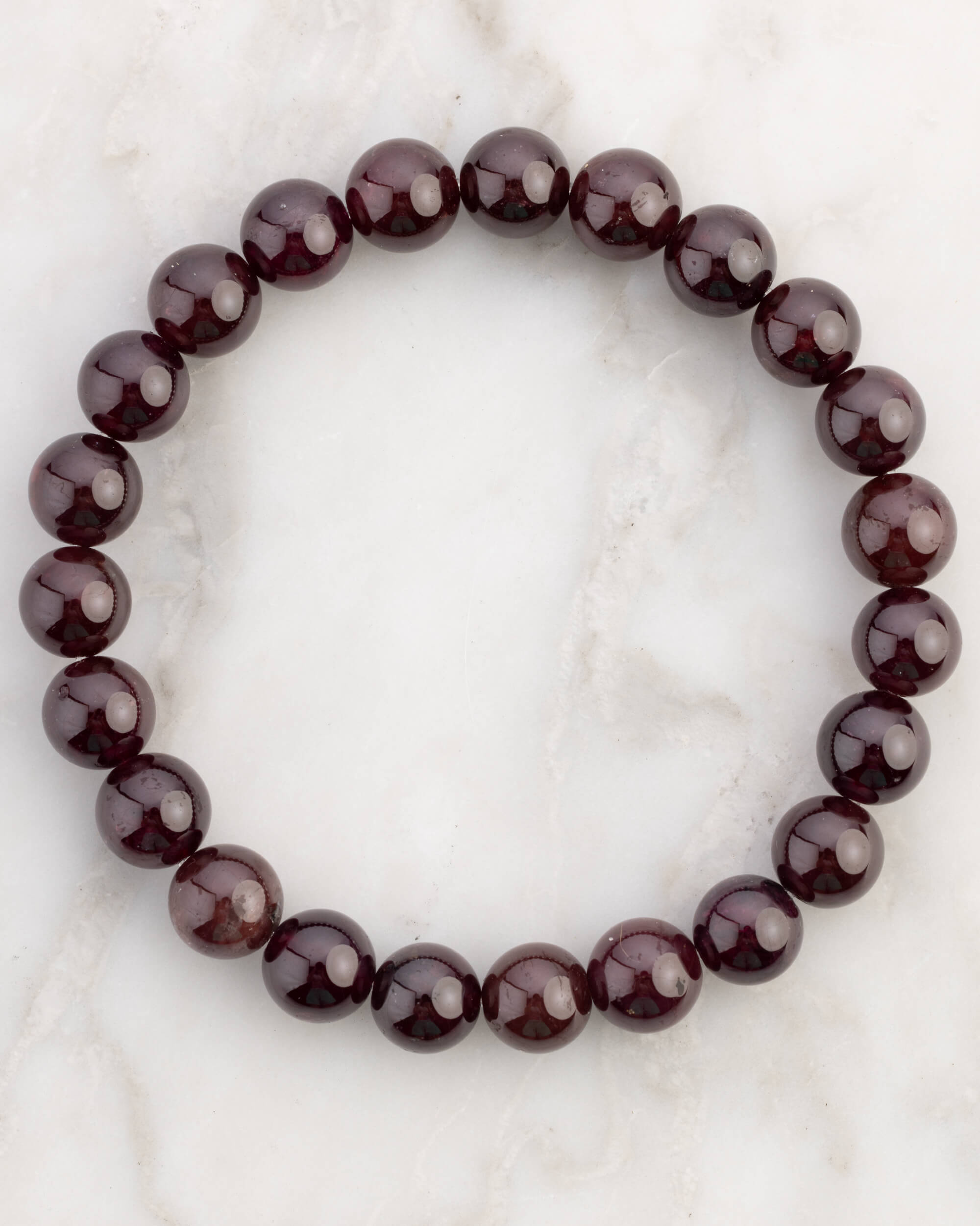 Pulsera de Granate Estrella de 8 mm, pieza completa en círculo sobre mármol claro
