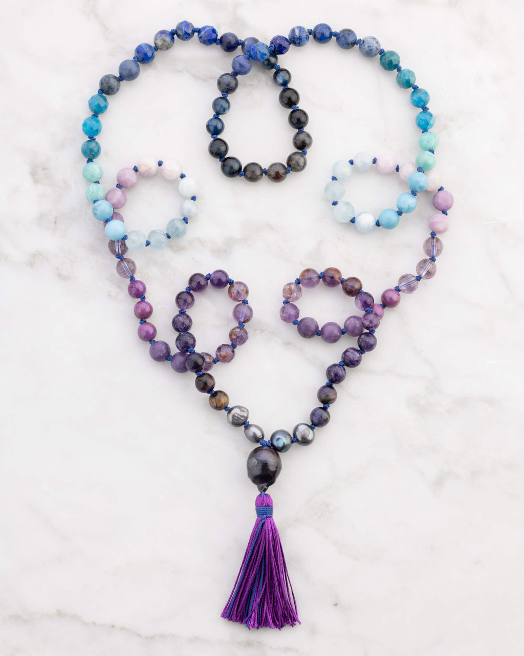 Japa Mala Universo enrollado en forma de corazon junto a sus pulseras a juego