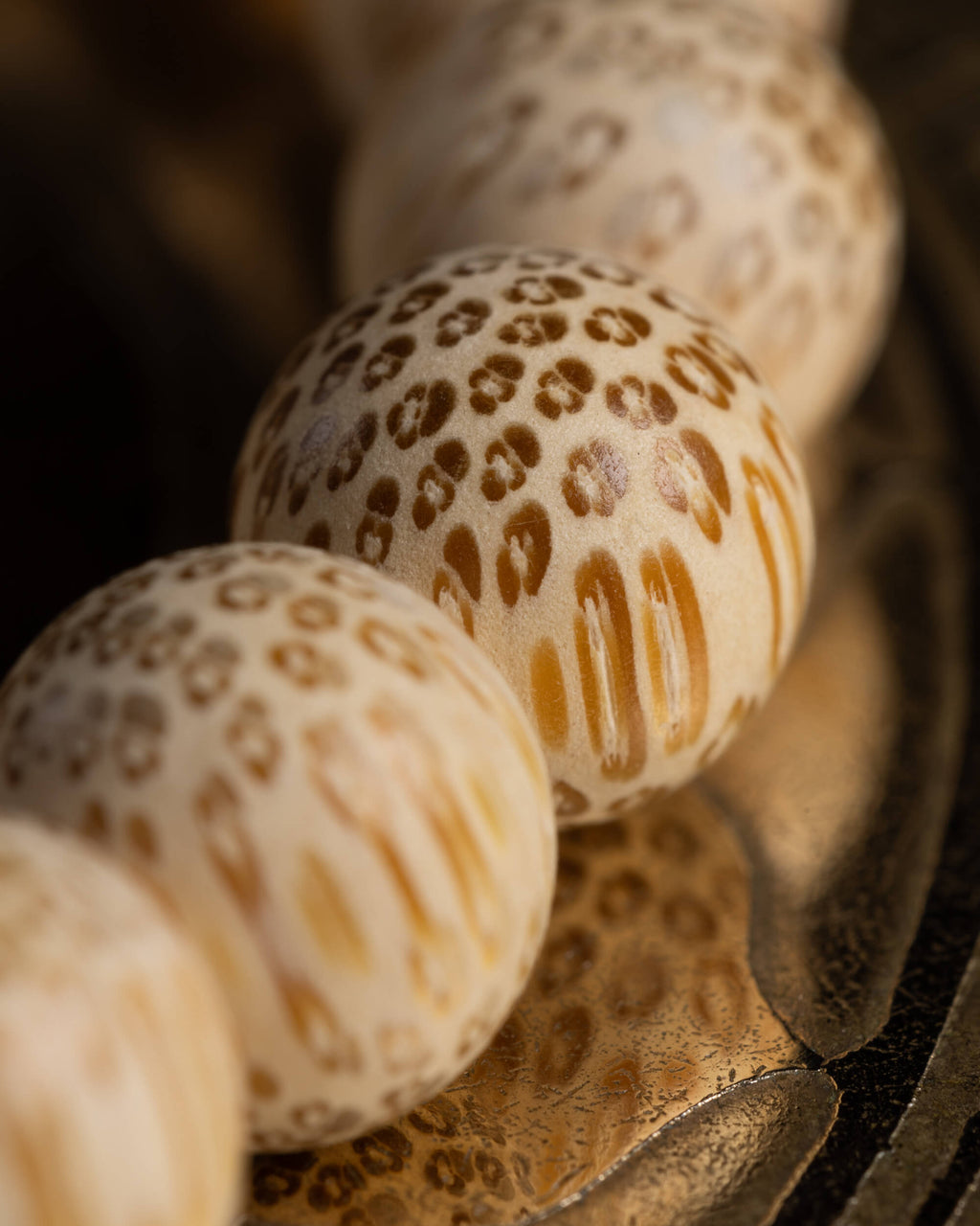 Detalle macro de las cuentas de Madera de Bambú con patrón moteado natural
