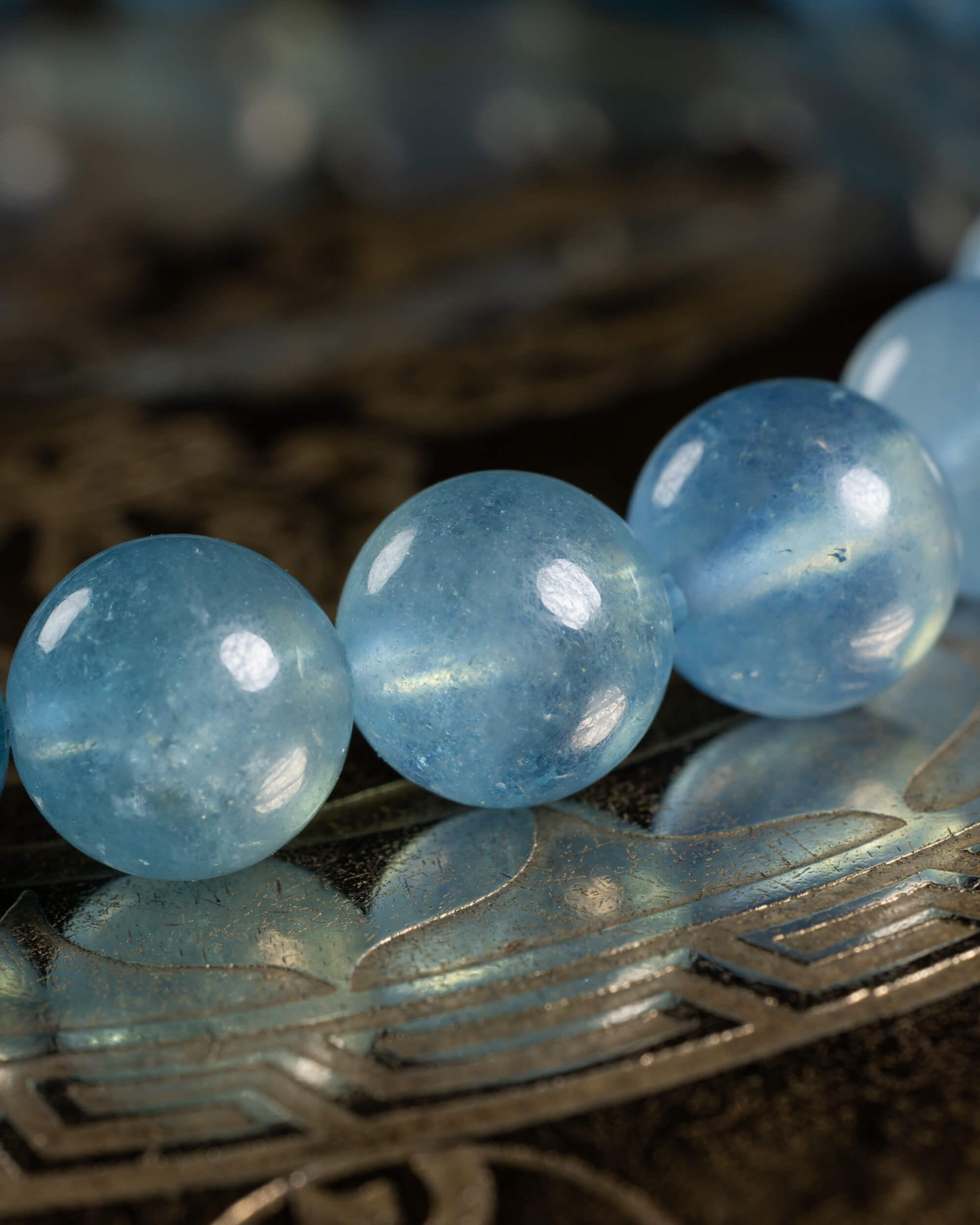 Detalle macro de cuentas de Aguamarina translúcidas con vetas azules internas