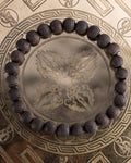Pulsera de Madera de Ebano tallada con hexagonos, pieza completa sobre soporte grabado