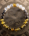 Pulsera Amaterasu de Selenita, Obsidiana Plateada y Ámbar, pieza completa sobre disco grabado