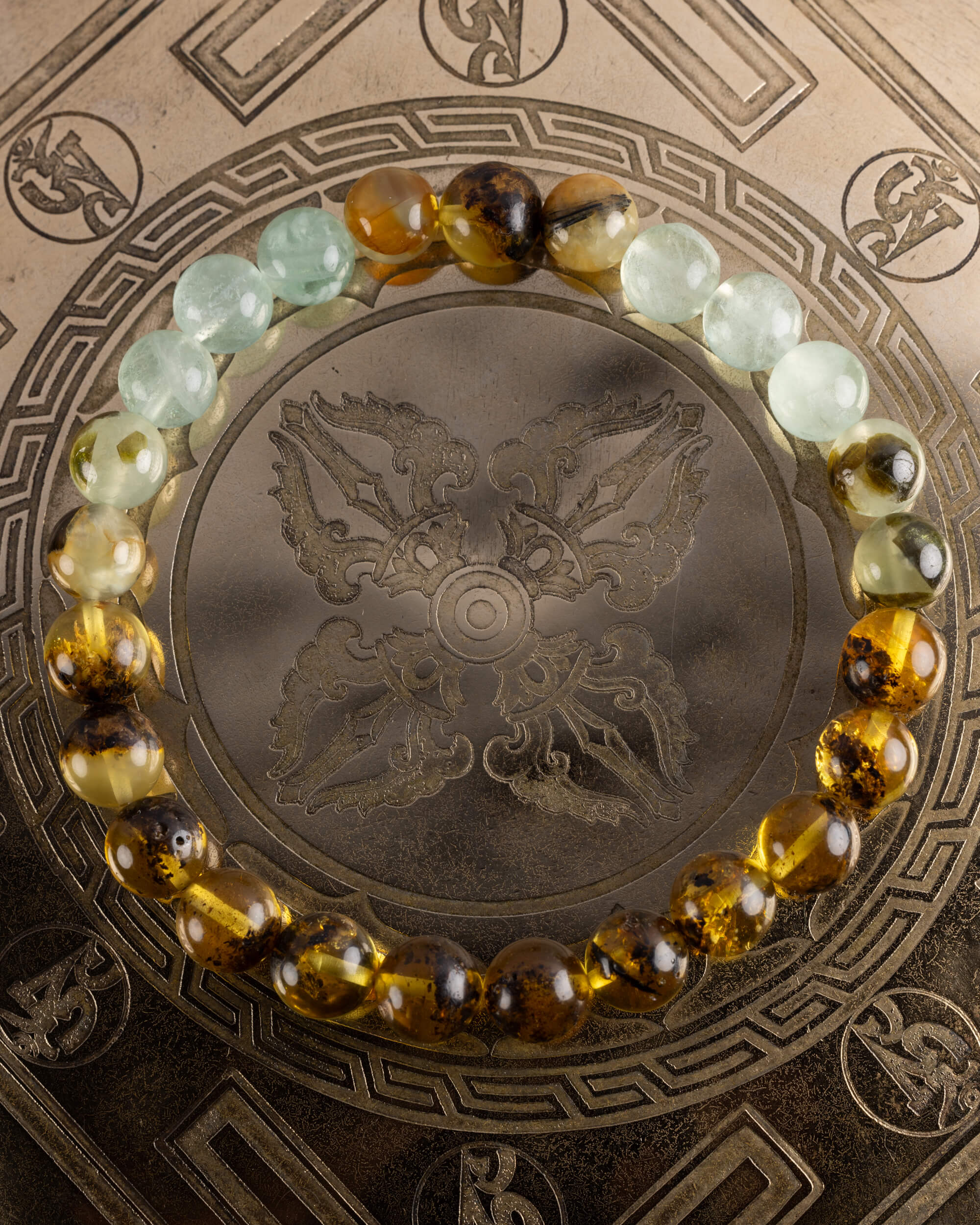 Pulsera Surya de Fluorita, Prehnita y Ámbar, pieza completa sobre disco grabado