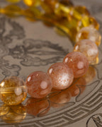 Detalle macro de las cuentas de Piedra Sol Roja y Citrino de la pulsera Sol Invictus