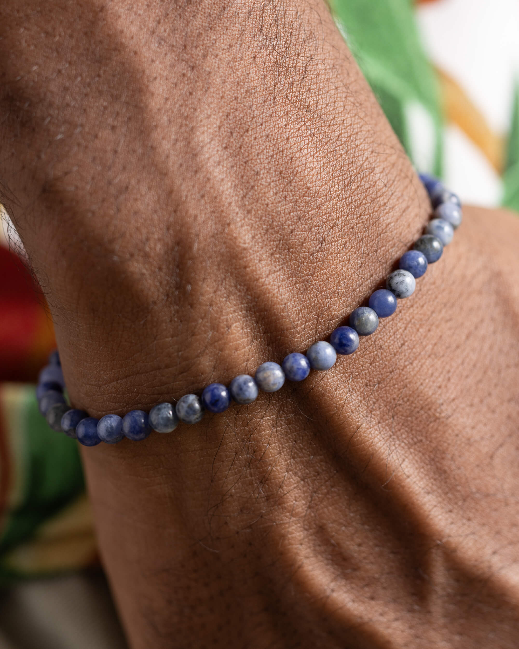 Pulsera de Sodalita puesta en la muñeca, vista cercana de las cuentas azules