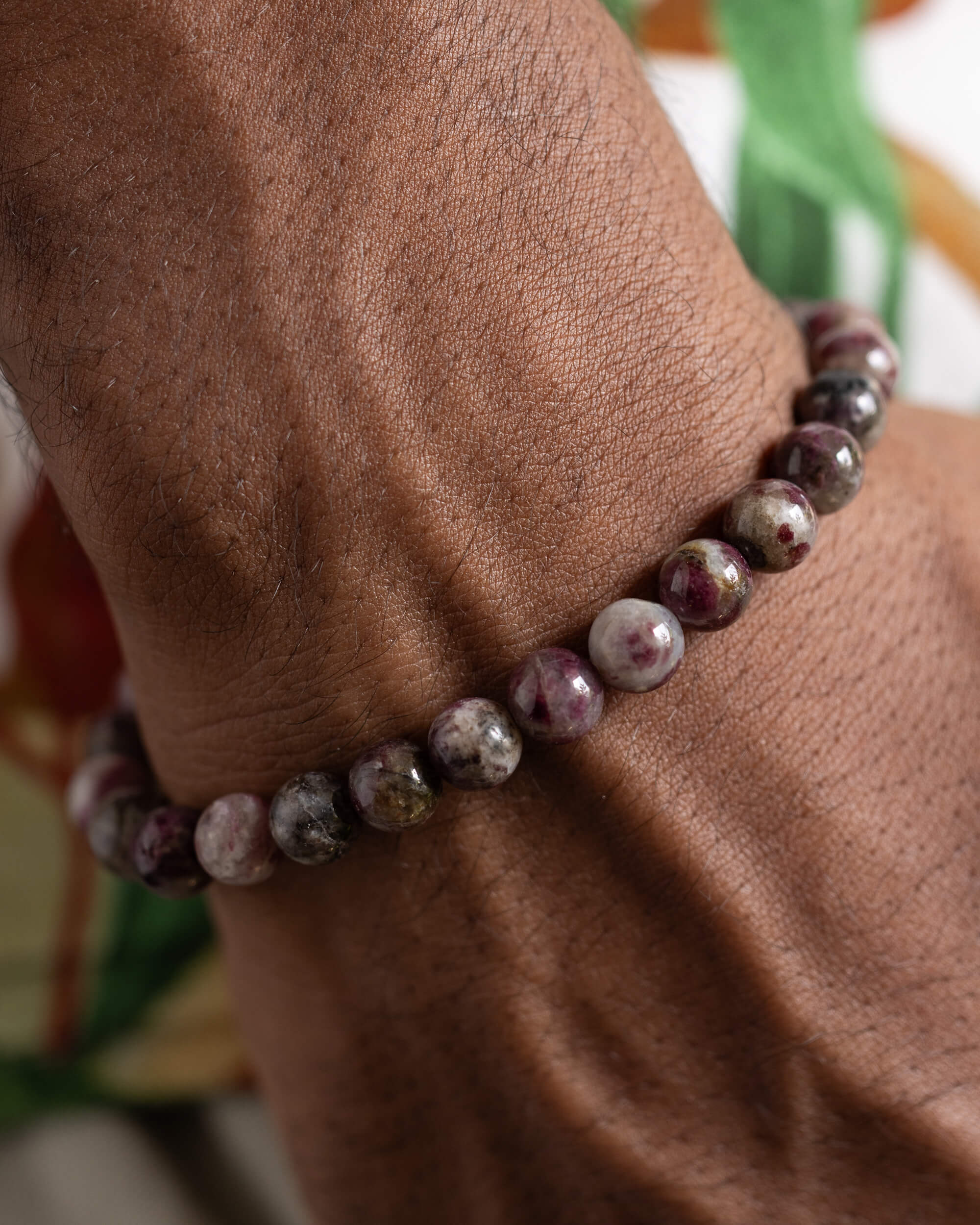 Pulsera de Turmalina Rubelita puesta en la muñeca, detalle cercano de las cuentas