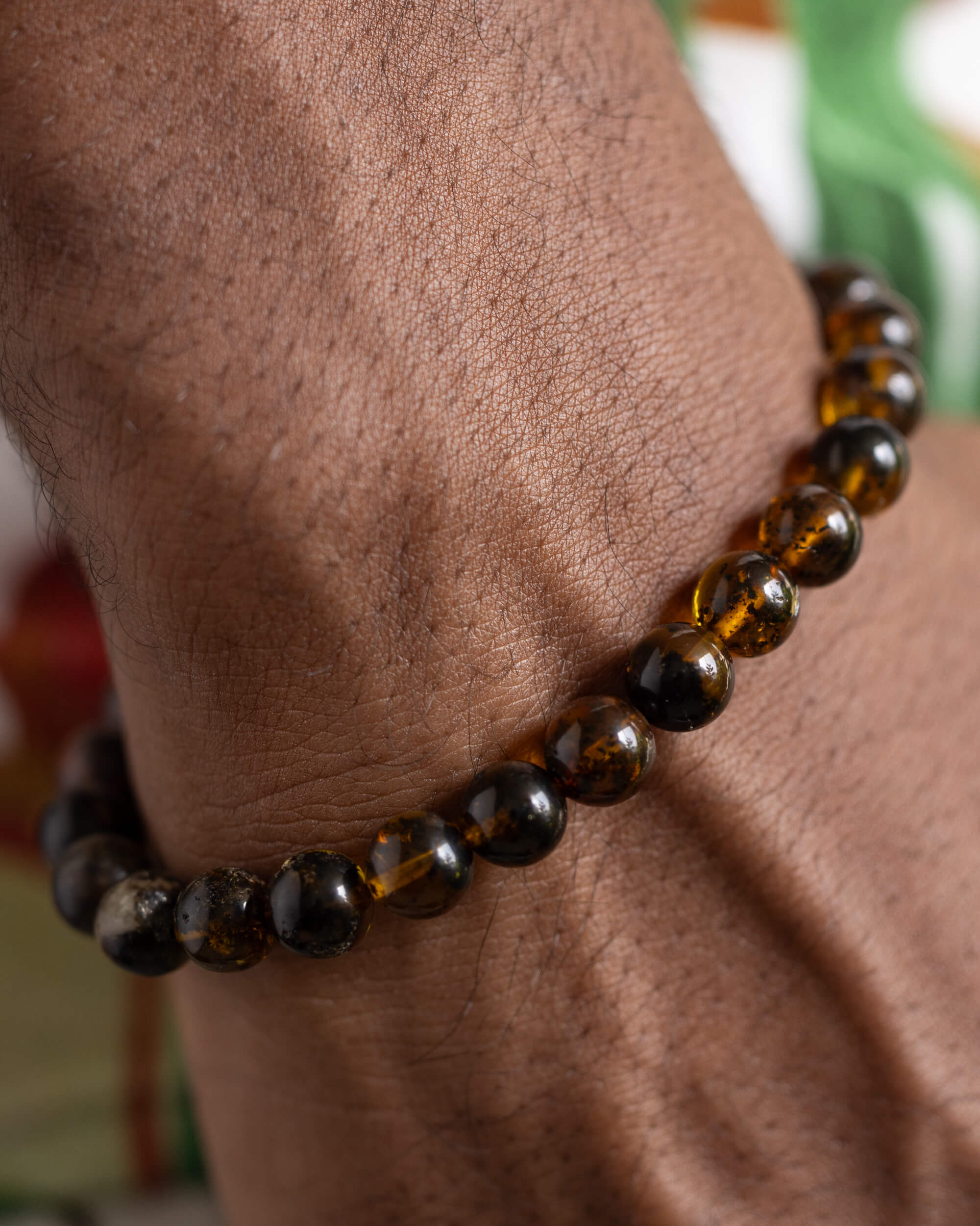Pulsera Kinich Ahau puesta en la muñeca, cuentas de Ámbar en primer plano