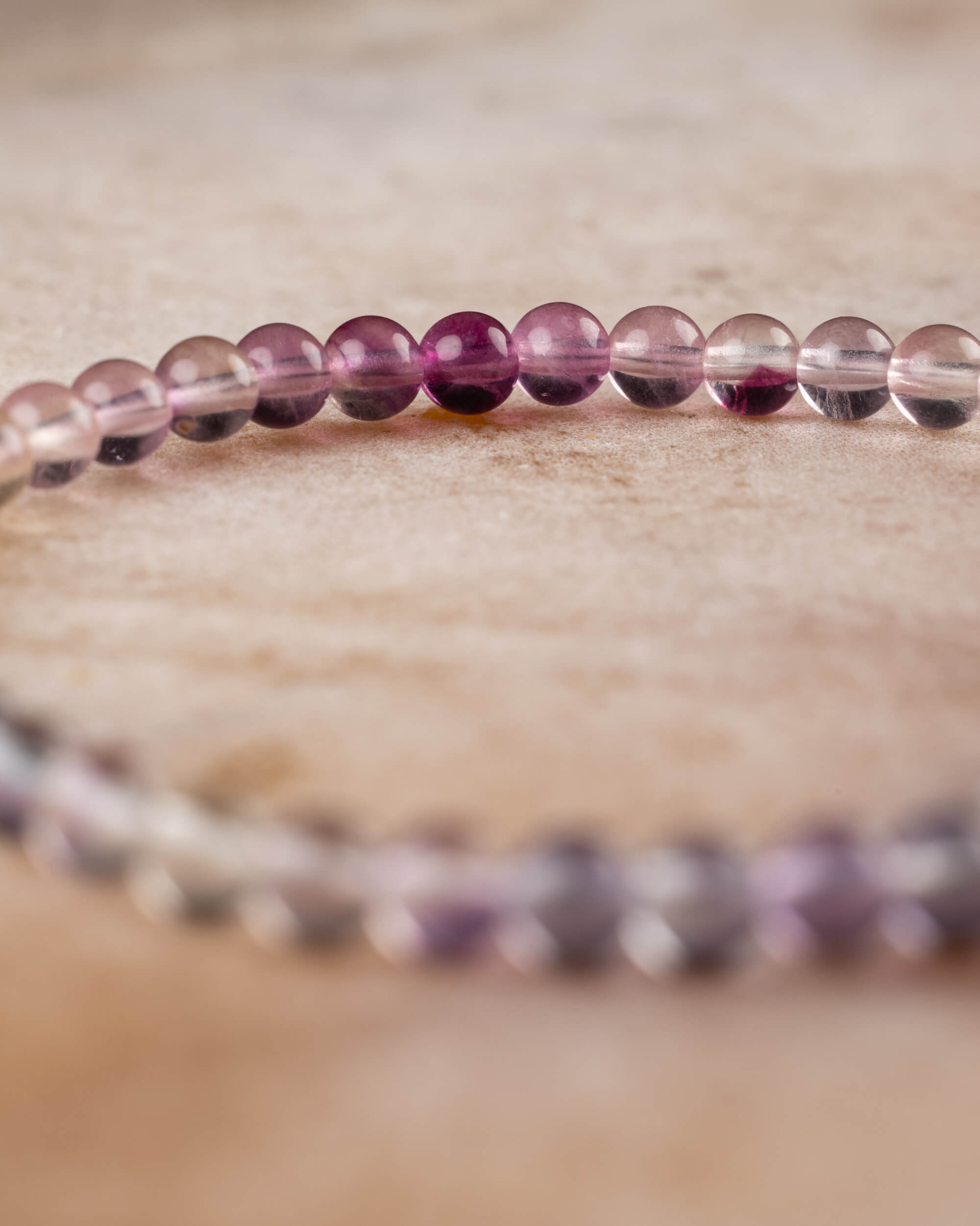 Pulsera de Fluorita Arcoíris mostrando el degradado de tonos claros a morados