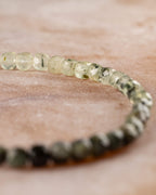 Pulsera de Prehnita en perspectiva, de tonos claros hacia verde oscuro