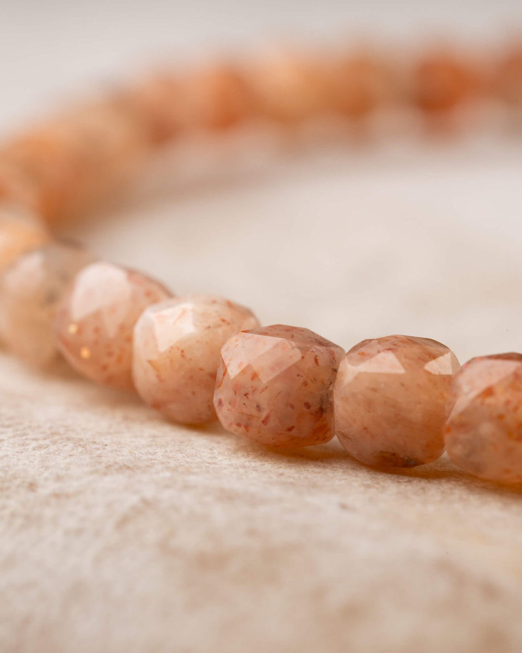 Pulsera de Piedra Sol Naranja en perspectiva, círculo completo sobre superficie clara