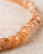 Detalle macro de las cuentas facetadas de Piedra Sol Naranja con brillos