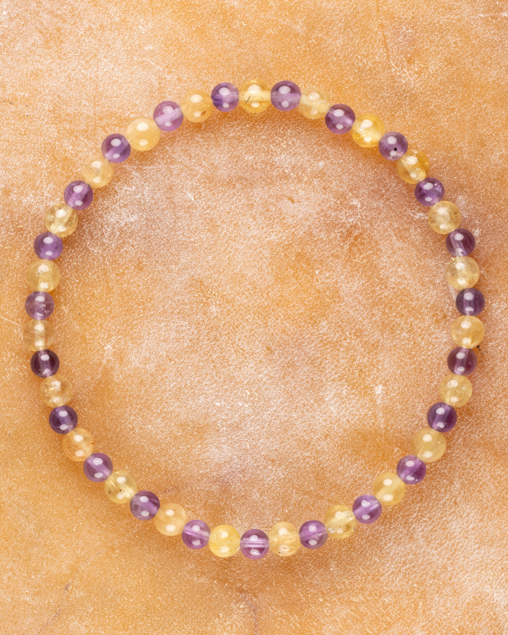Pulsera de Amatista y Cuarzo Rutilado, pieza completa en círculo sobre superficie clara
