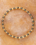 Pulsera de Cuarzo Rutilado y Pirita, pieza completa en círculo sobre superficie clara