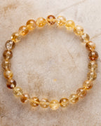 Pulsera de Citrino de 7.5 mm, pieza completa en círculo sobre superficie clara
