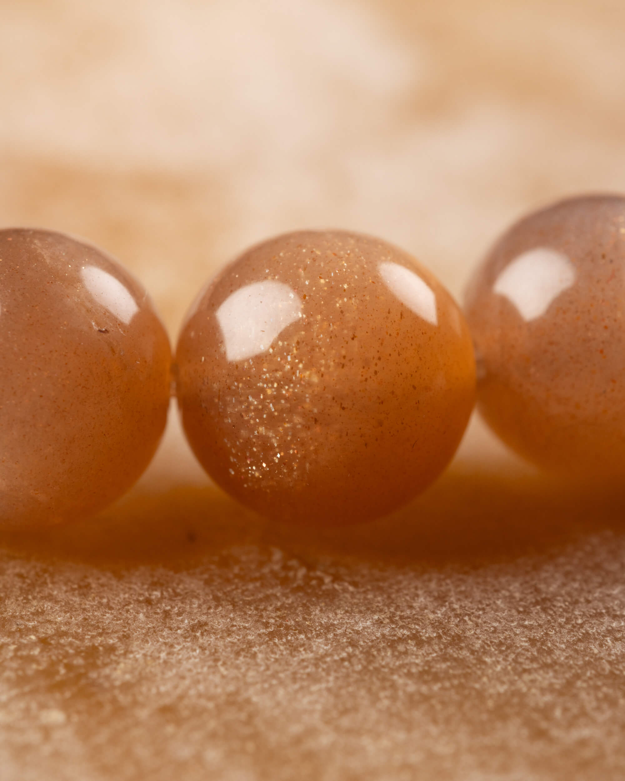 Detalle macro de las cuentas brillantes de Piedra Sol Naranja