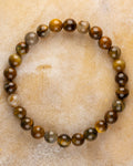 Pulsera de Pietersita Amarilla de 8 mm, pieza completa en círculo sobre superficie clara