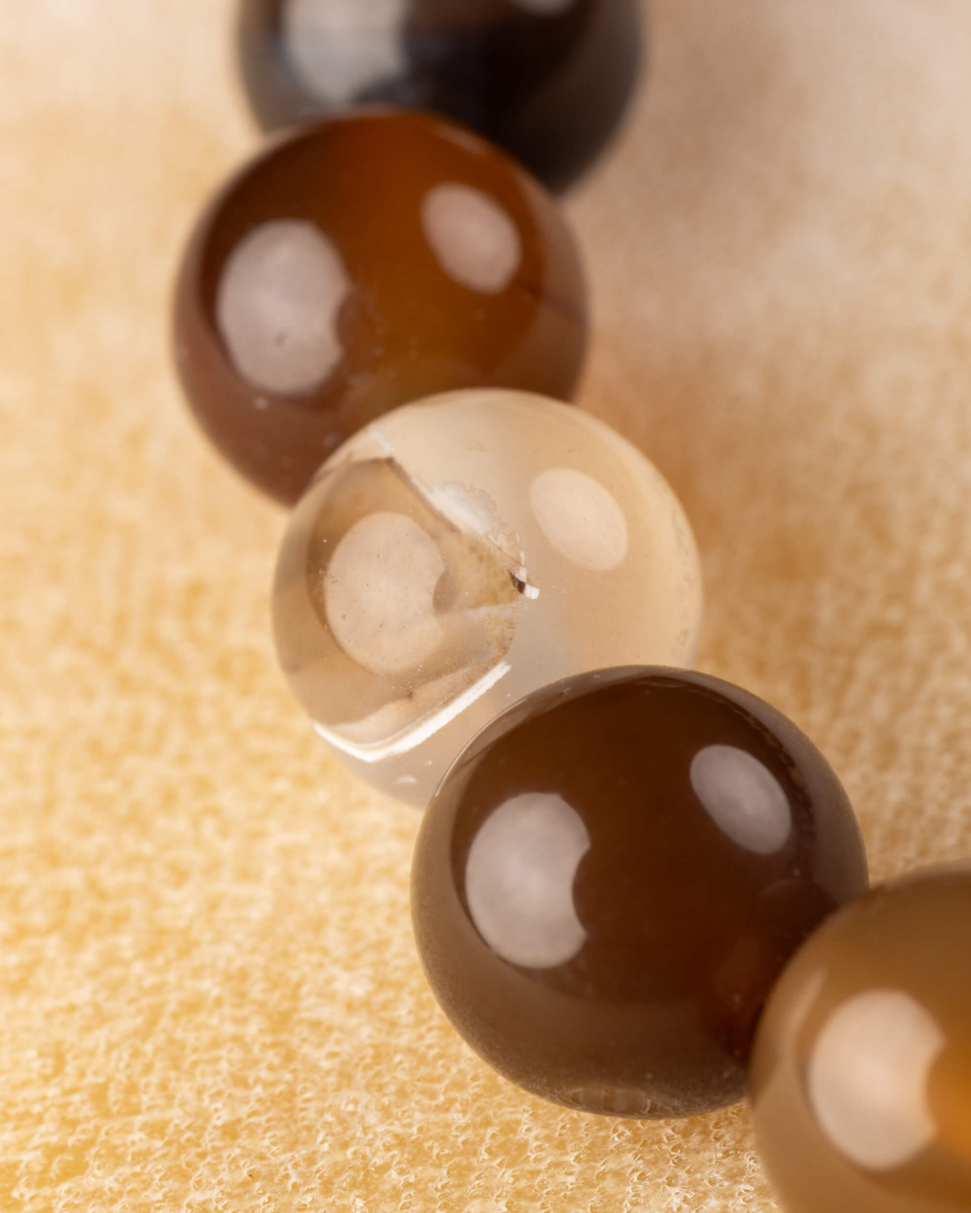 Cuentas de Ágata Grano de Café en fila vertical con tonos marrón y crema