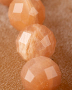 Detalle macro de las cuentas facetadas de Piedra Sol Naranja