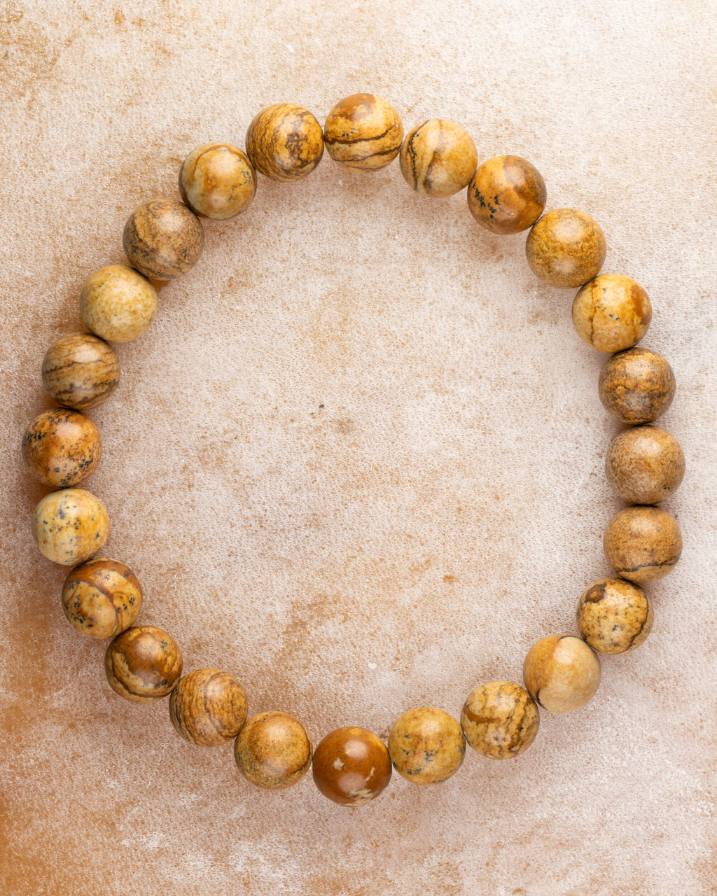 Pulsera de Jaspe Paisaje de 8 mm, pieza completa en círculo sobre superficie clara