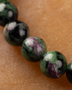 Macro de cuentas de Zoisita verdes con vetas rosadas y negras de la pulsera