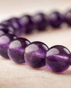 Pulsera de Amatista en curva, cuentas nítidas al frente y difuminadas atrás