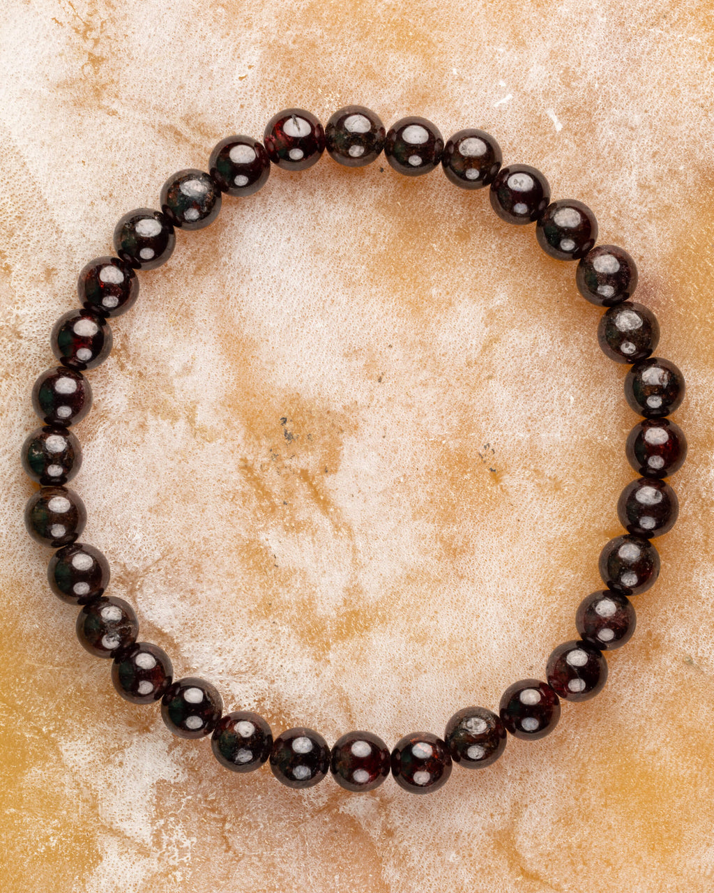 Pulsera de Granate Rojo, pieza completa en círculo sobre superficie clara