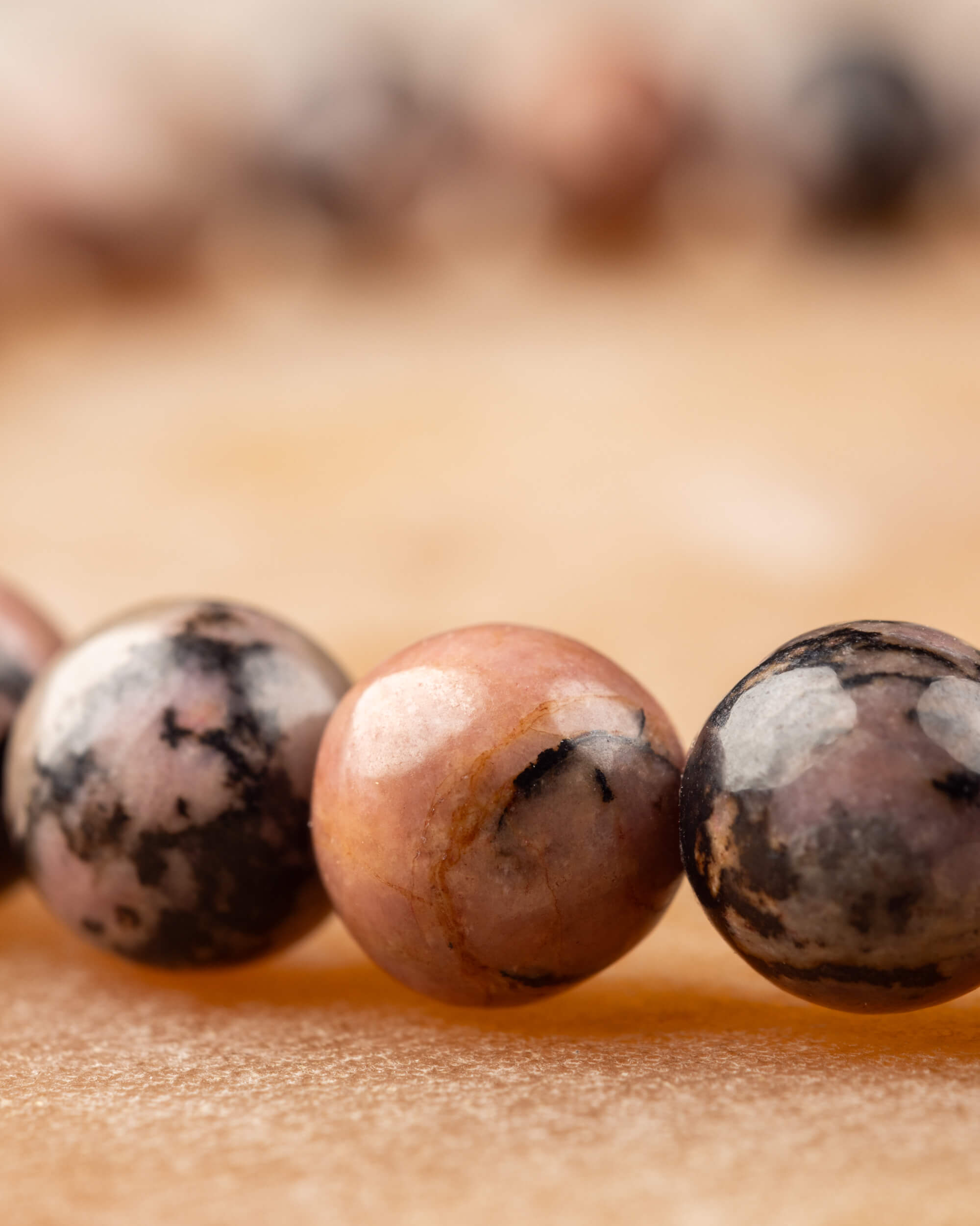 Perspectiva de la pulsera de Rodonita encaje negro, cuenta con vetas negras al frente