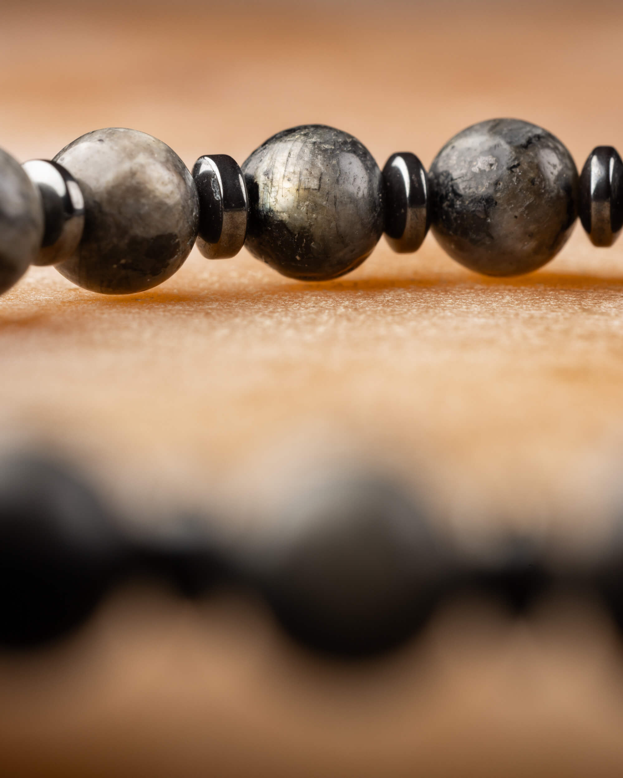 Pulsera de Larvikita y Hematita vista de cerca con la fila completa detrás