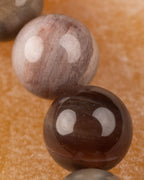 Detalle macro de una cuenta clara con manchas cafés de Madera Petrificada