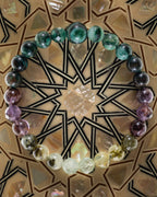 Pulsera zodiacal Escorpio, pieza completa sobre mosaico decorativo con estrella geometrica