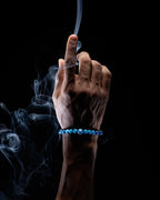 Pulsera zodiacal Libra puesta en la muñeca, con humo de copal alrededor