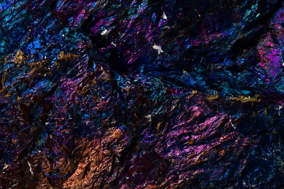 Fotografía macro de la Calcopirita: superficie rugosa con tornasol azul, violeta, magenta y cobre. Serie La Disolución, cuadro 06.