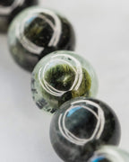 Detalle macro de las cuentas de Prehnita con vetas verdes y negras